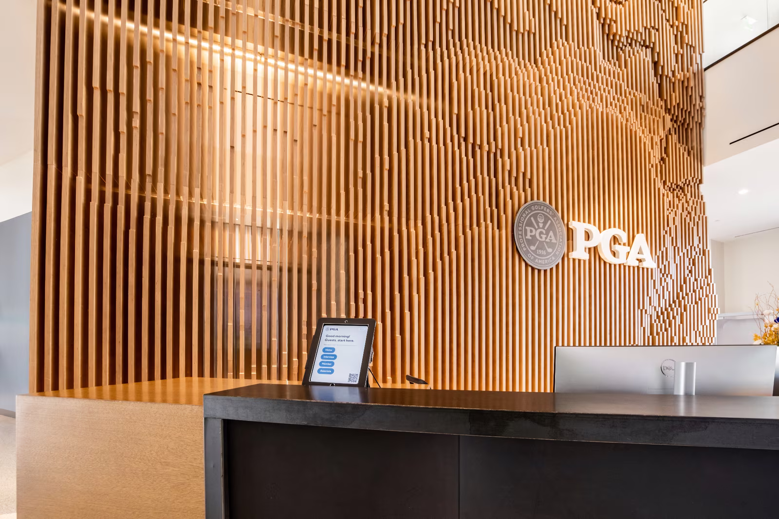 PGA Headquarters reception desk with wall installation behind
